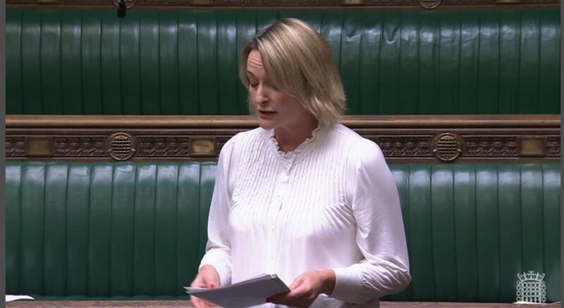 Jessica Morden stands in Parliament during October 2024. She is wearing a white blouse and is standing in front of green benches in the House of Commons