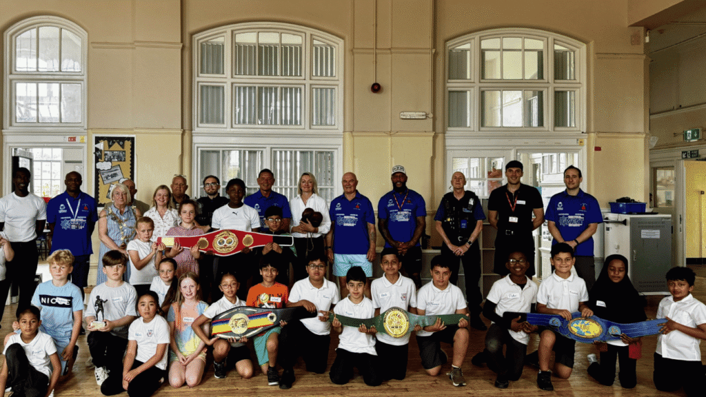 Jessica Morden MP and other elected representatives of Newport stand with the trainers from St Joseph's Boxing Club and group of children at St. Woolos Primary School, Newport